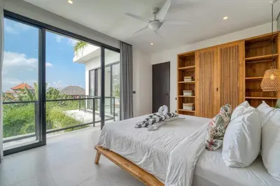 a bedroom with a bed and a large window at Rooftop Villa Elegant 4BR Retreat in Umalas in Kerobokan