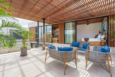 a patio with chairs and a bed and a bedroom at Luxury Resort of 4 villas 11 BR Seminyak in Seminyak