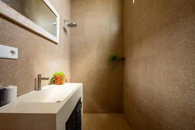 a bathroom with a sink and a mirror at Casa Ombak in Kerobokan