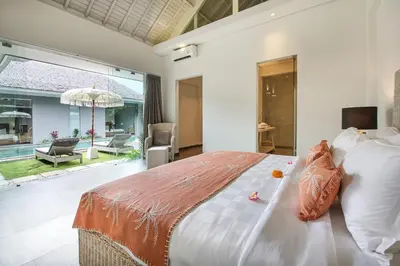 a bedroom with a large bed and a large window at Villa Shankara 1 in Canggu