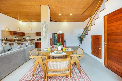 a dining room and kitchen with a table and chairs at Villa Anvira in Seminyak