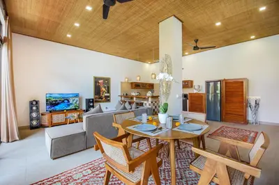 a living room with a table and a couch at Villa Anvira in Seminyak