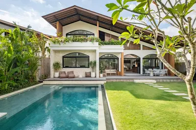 an exterior view of a house with a swimming pool at Villa Nusa in Canggu