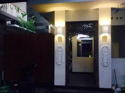 a front door of a building with lights on it at Pondok Sutya in Kuta