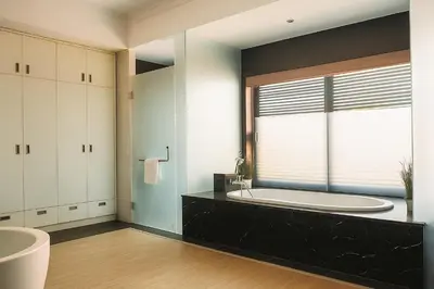 a bathroom with a large tub and a large window at Villa Avrora Batubelig in Canggu