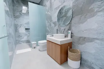 a bathroom with a toilet and a sink and a mirror at Arjuna Villa in Seminyak
