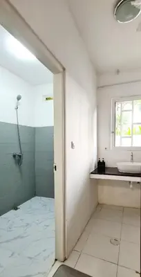 a bathroom with a sink and a mirror and a window at Villa Umah JD Umalas 3 kamar private pool in Canggu