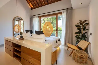 a bedroom with a bed and a desk and a window at 2BR Modern Mediterranean Villa Near Nook in Badung