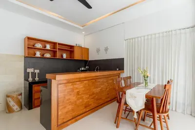 a kitchen with a table and chairs in a room at Casa Amore Villa in Berawa Beach - Canggu in Canggu