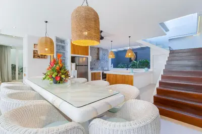 a dining room with a glass table and chairs at Berawa -Ocean View 5 Bed, Walk to Beach, Sleeps 10 in Canggu