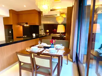 a dining room table with chairs and a kitchen at Bloomingville Villas in Nusa Dua in Nusa Dua