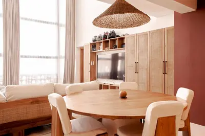a living room with a table and a couch at Gate 11 Apartments in Denpasar