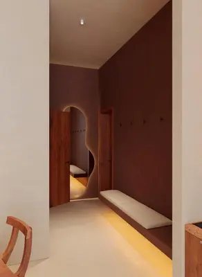 a bedroom with brown walls and a bed with a mirror at Gate 11 Apartments in Denpasar