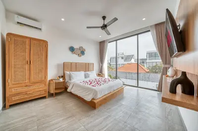 a bedroom with a bed and a large window at Tropical and Minimalist 2bd Umalas Villa with Private Pool in Canggu