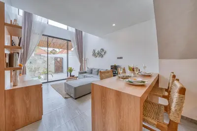 a living room with a table and a couch at Tropical and Minimalist 2bd Umalas Villa with Private Pool in Canggu