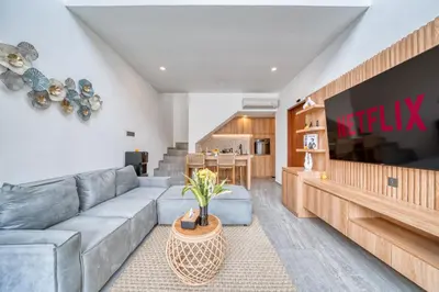 a living room with a couch and a table at Tropical and Minimalist 2bd Umalas Villa with Private Pool in Canggu
