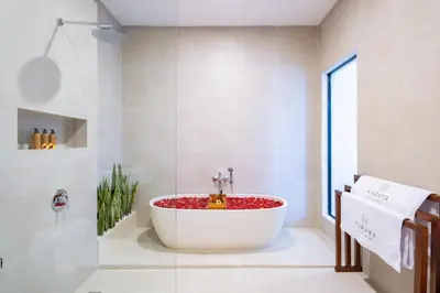 a bath tub in a bathroom with a window at Karaya Villas Umalas - Free In-Villa Culture Immersion Programs in Kerobokan