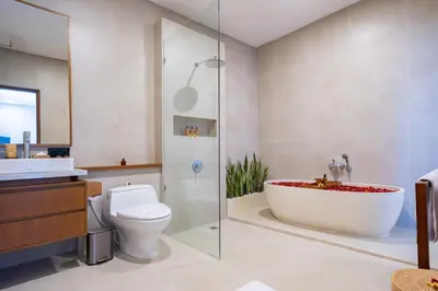 a bathroom with a tub and a toilet and a sink at Karaya Villas Umalas - Free In-Villa Culture Immersion Programs in Kerobokan