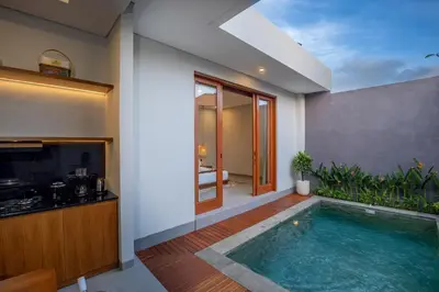 a swimming pool in the middle of a house at Karaya Villas Umalas - Free In-Villa Culture Immersion Programs in Kerobokan