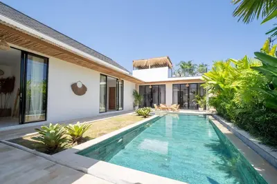an image of a swimming pool in front of a villa at Villa Amie Elegant 5BR with Pool & Rooftop Umalas in Canggu