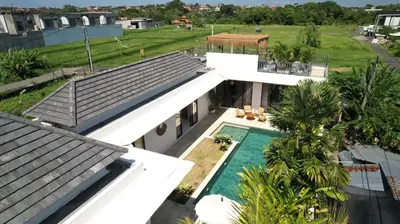an aerial view of a house with a swimming pool at Villa Amie Elegant 5BR with Pool & Rooftop Umalas in Canggu