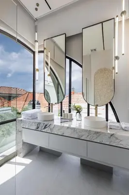 a bathroom with two sinks and mirrors on a counter at Brand New Luxury Design Villa by Amare Villas 4 in Badung