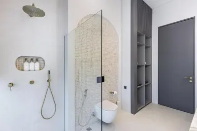 a bathroom with a shower with a toilet and a glass door at Brand New Luxury Design Villa by Amare Villas 4 in Badung