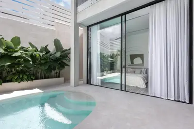 a house with a swimming pool in a bedroom at Brand New Luxury Design Villa by Amare Villas 4 in Badung