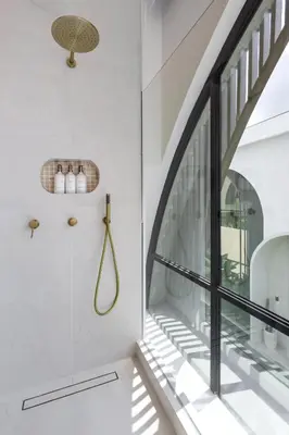 a bathroom with white walls and a glass window at Brand New Luxury Design Villa by Amare Villas 4 in Badung
