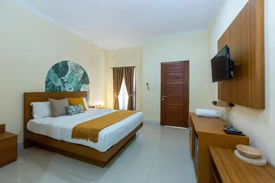 a bedroom with a bed and a television in it at Cove Raddeyapa in Canggu