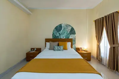 a bedroom with a large bed in a room at Cove Raddeyapa in Canggu