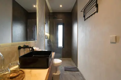 a bathroom with a black sink and a toilet at Villa Teide by BaliSuperHost in Canggu