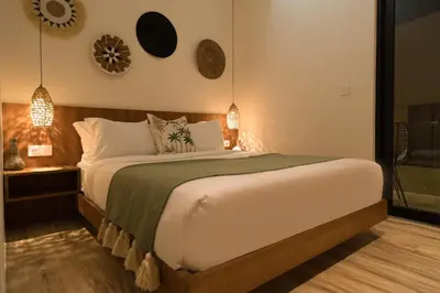 a bedroom with a bed and two clocks on the wall at Villa Teide by BaliSuperHost in Canggu