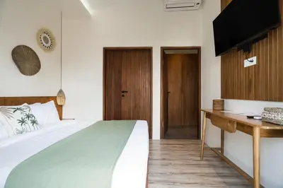 a bedroom with a large bed and a desk at Villa Teide by BaliSuperHost in Canggu