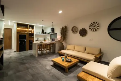 a living room with a couch and a table at Villa Teide by BaliSuperHost in Canggu