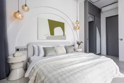 a bedroom with a large bed with a white bedspread at Brand New Luxury Design Villa by Amare Villas 2 in Badung