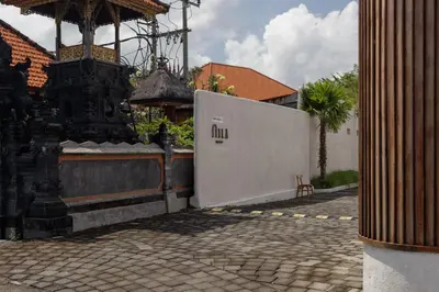 a building with a fence next to a brick sidewalk at Lavanya Villa Berawa beach in Canggu