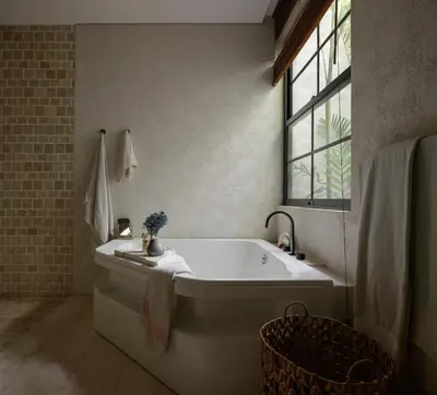 a white bath tub in a bathroom with a window at Lavanya Villa Berawa beach in Canggu