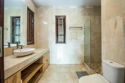 a bathroom with a sink and a toilet at Vase 2BR Villa Seminyak in Seminyak