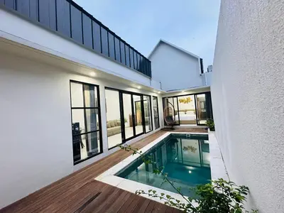 a swimming pool in the middle of a house at Athalia Villa Seminyak in Seminyak