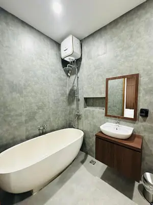 a bathroom with a white bath tub and a sink at Athalia Villa Seminyak in Seminyak