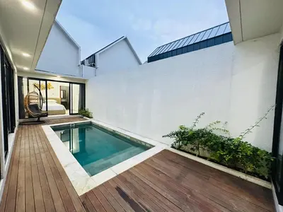a swimming pool in the middle of a house at Athalia Villa Seminyak in Seminyak