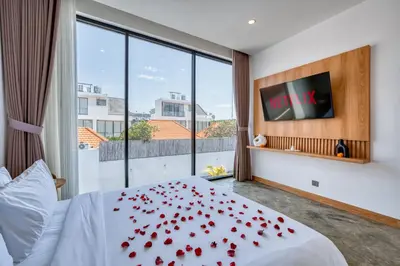 a bedroom with a bed with red roses on it at Modern 3bd Tropical Villa with Pool in Central Umalas in Canggu