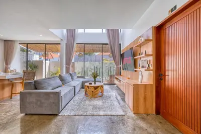a living room with a couch and a table at Modern 3bd Tropical Villa with Pool in Central Umalas in Canggu