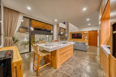 a kitchen with a large island in the middle at Modern 3bd Tropical Villa with Pool in Central Umalas in Canggu