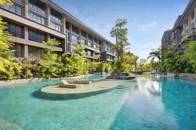 a swimming pool in front of a building at Anagata Tanjung Benoa 4 in Nusa Dua
