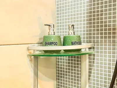 two green toothbrushes sitting on a shelf in a bathroom at Ratu Deandra Villa Seminyak in Seminyak