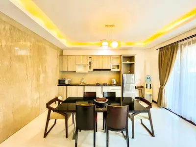 a kitchen and dining room with a table and chairs at Ratu Deandra Villa Seminyak in Seminyak