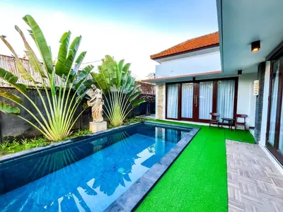 a swimming pool in the backyard of a villa at Ratu Deandra Villa Seminyak in Seminyak