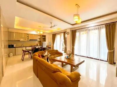 a living room with a couch and a table at Ratu Deandra Villa Seminyak in Seminyak